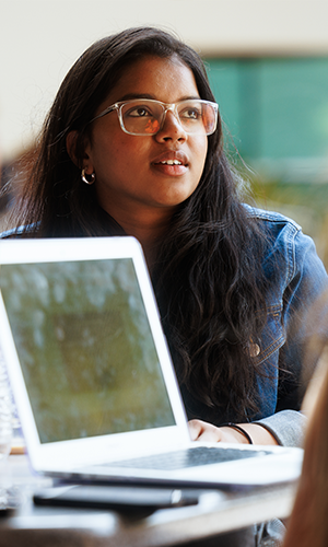 Siva Priya Bommareddy an international student from India living in Tempe, AZ studying both business entrepreneurship and marketing sits with peers on Tempe Campus on April 18, 2022