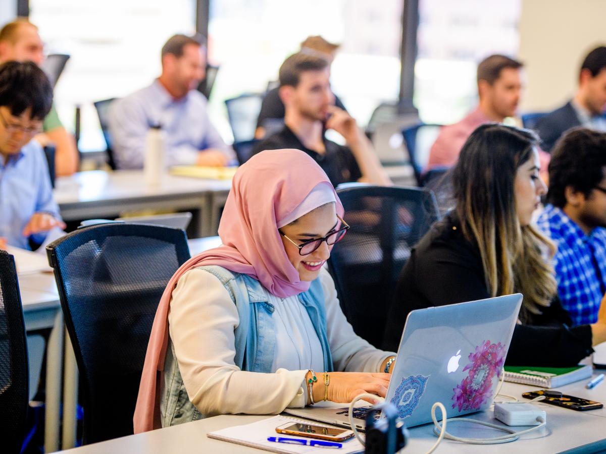 female-student-laptop-in-classroom