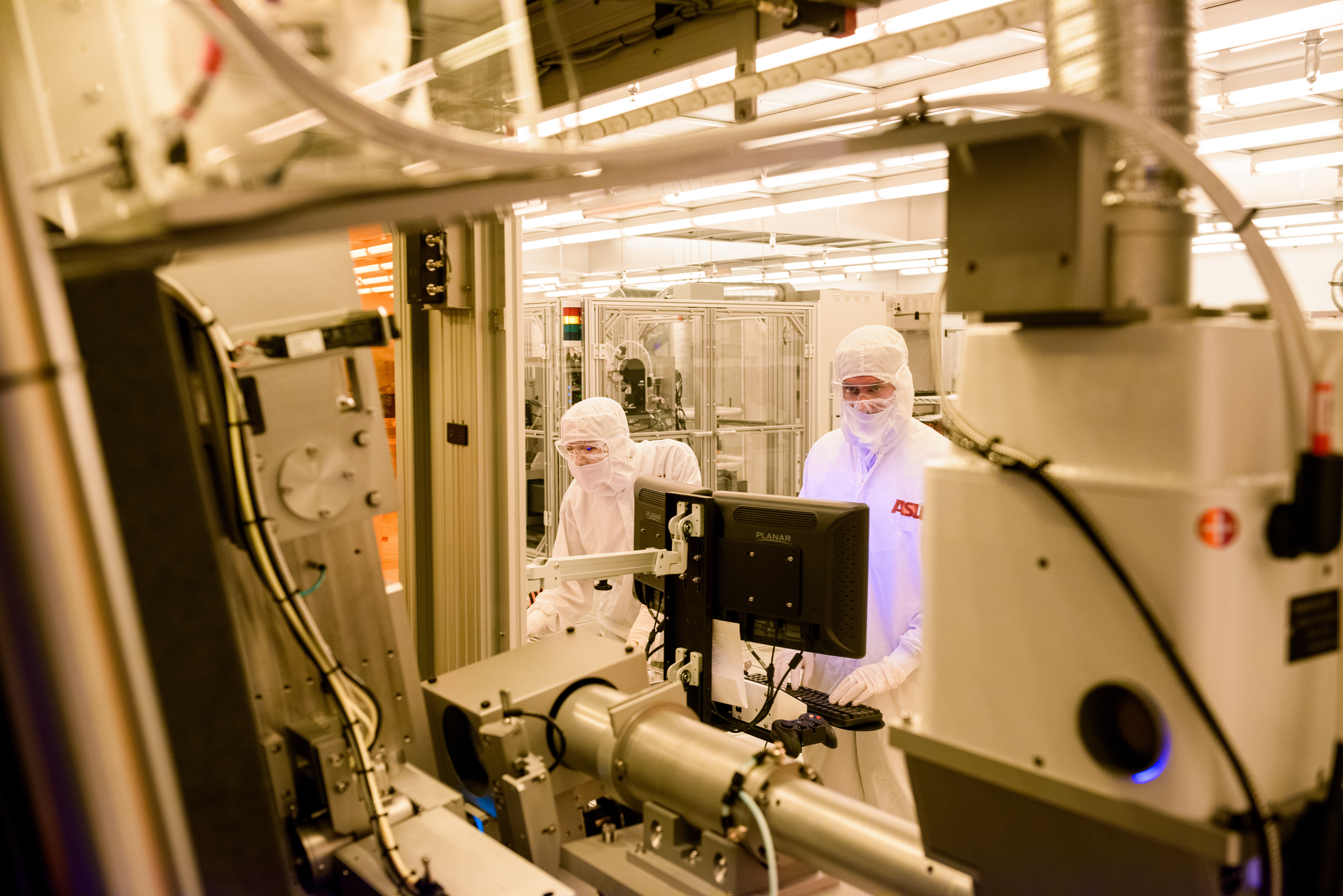 Two people working in a cleanroom