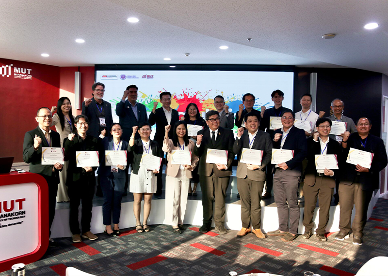 A group of people holding certificates in a formal setting.